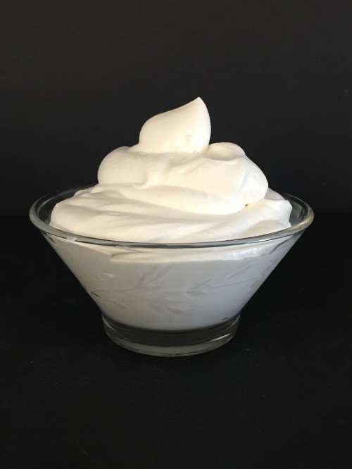 A glass bowl filled with maple vanilla whipped cream