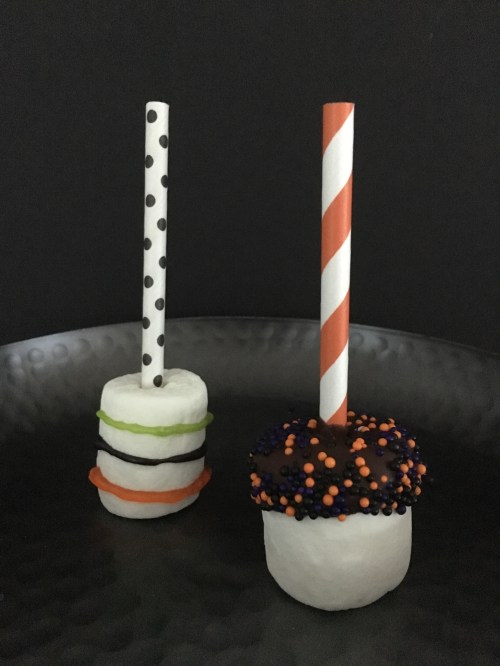 Two halloween marshmallow pops on a plate